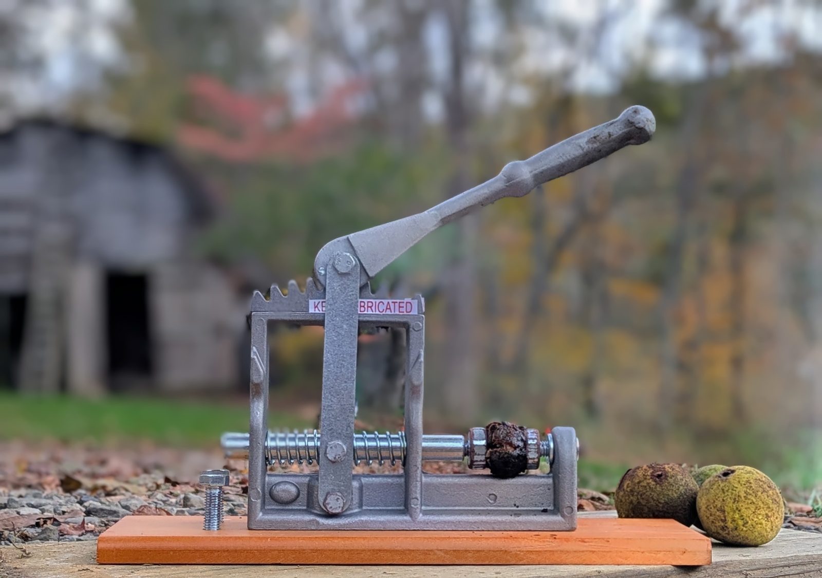 Heavy-duty black walnut cracker with lever handle on hardwood base